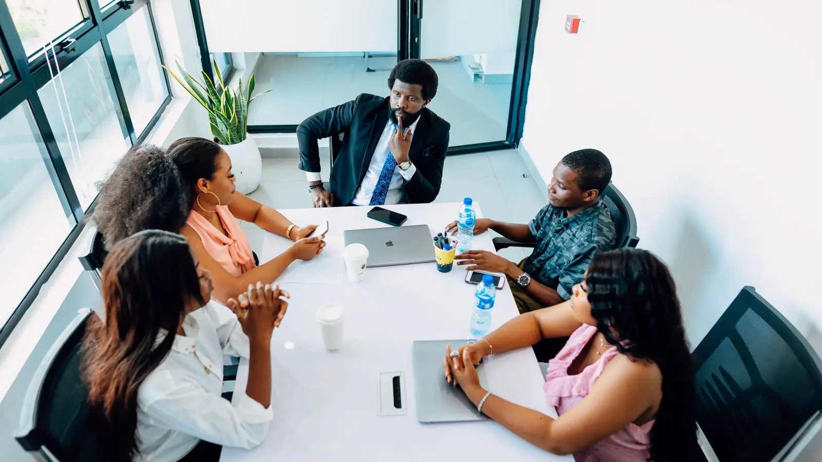 A management team around a boardroom table in a Lagos office
