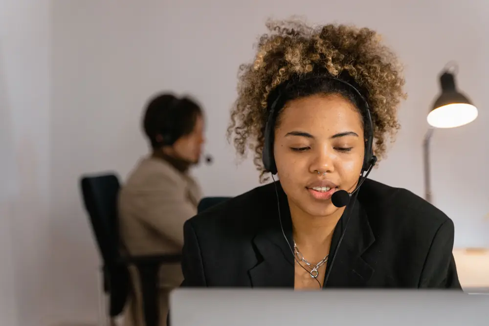 A consultant on a call at her desk, headset on