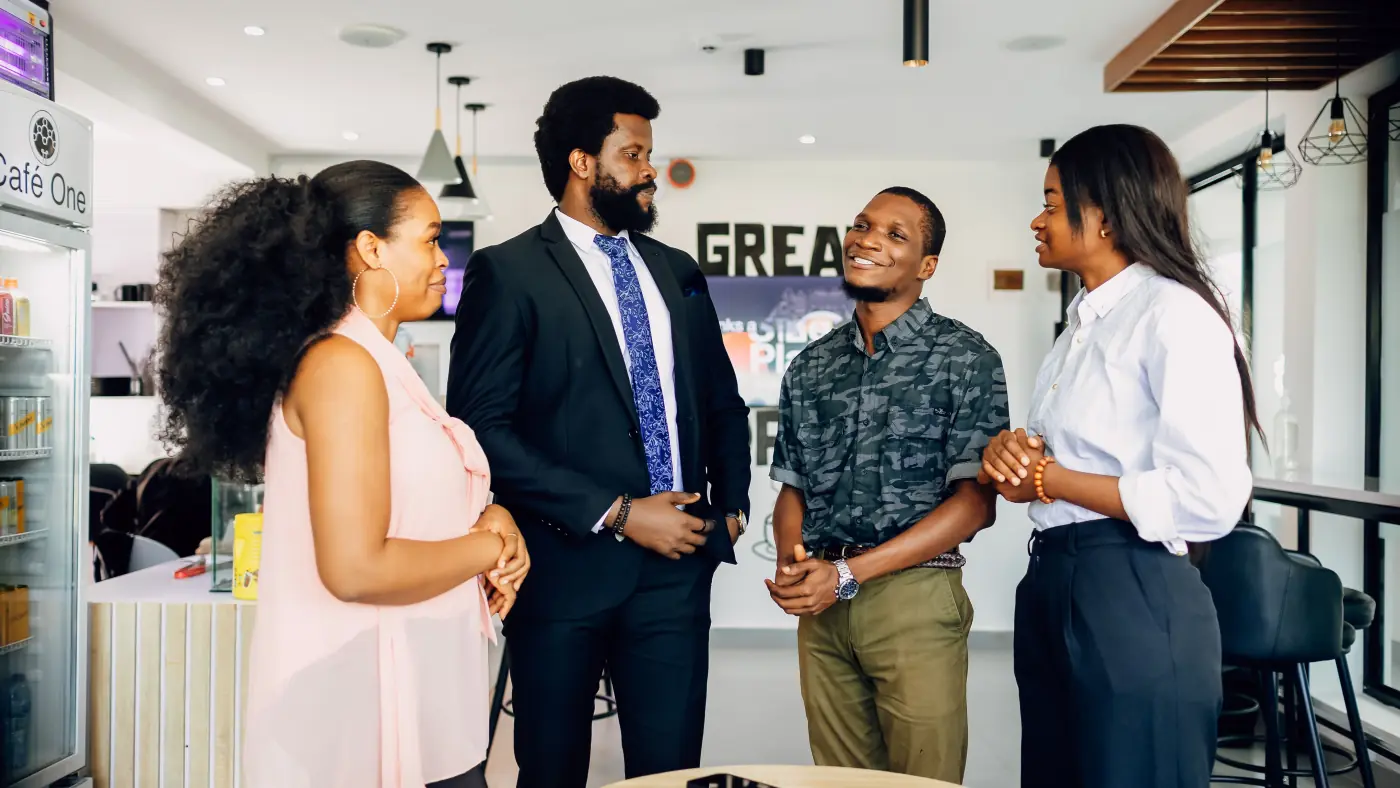 Colleagues talking in the break area of a Lagos office